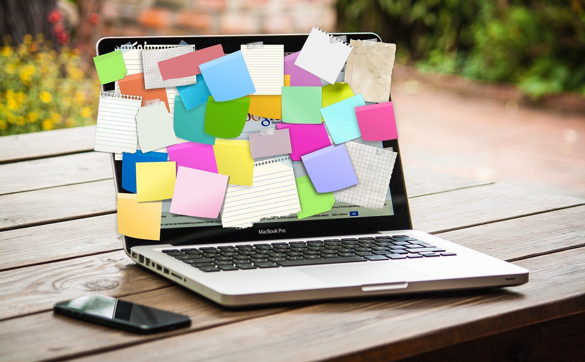 Laptop covered in colourful sticky notes