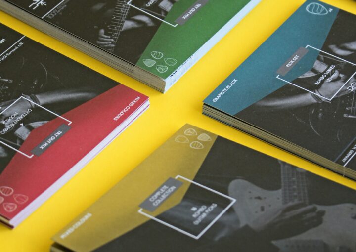 A row of brochures laid out on a yellow table