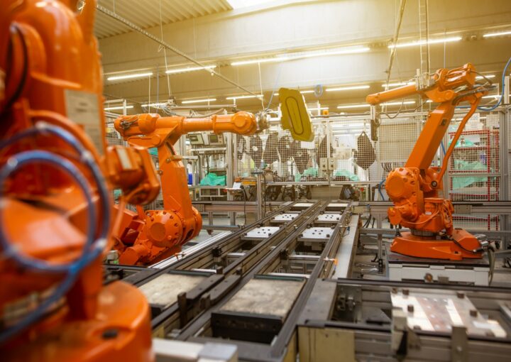 orange robots in a factory