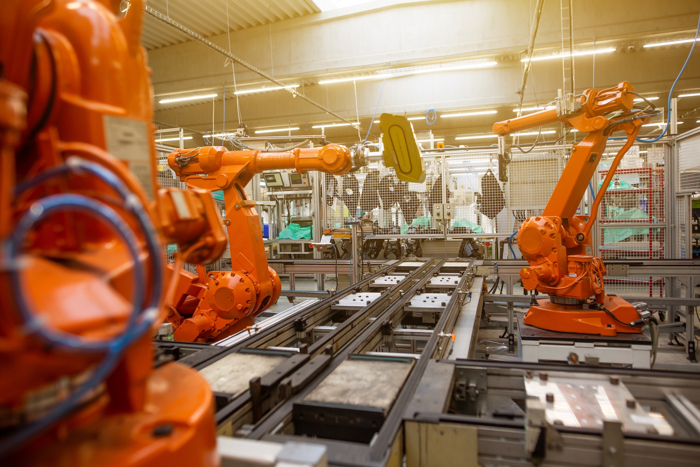 orange robots in a factory
