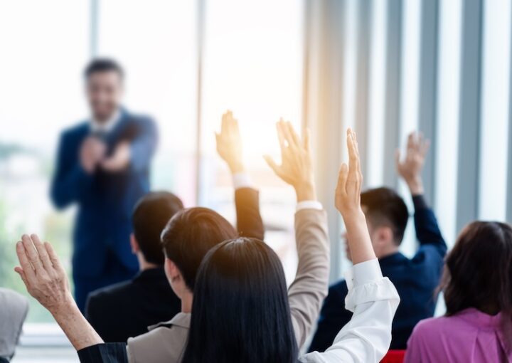 Business people raising their hands