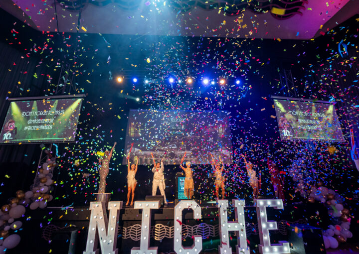 Niche Business Awards 2024 dancers pose on stage with confetti falling all around them