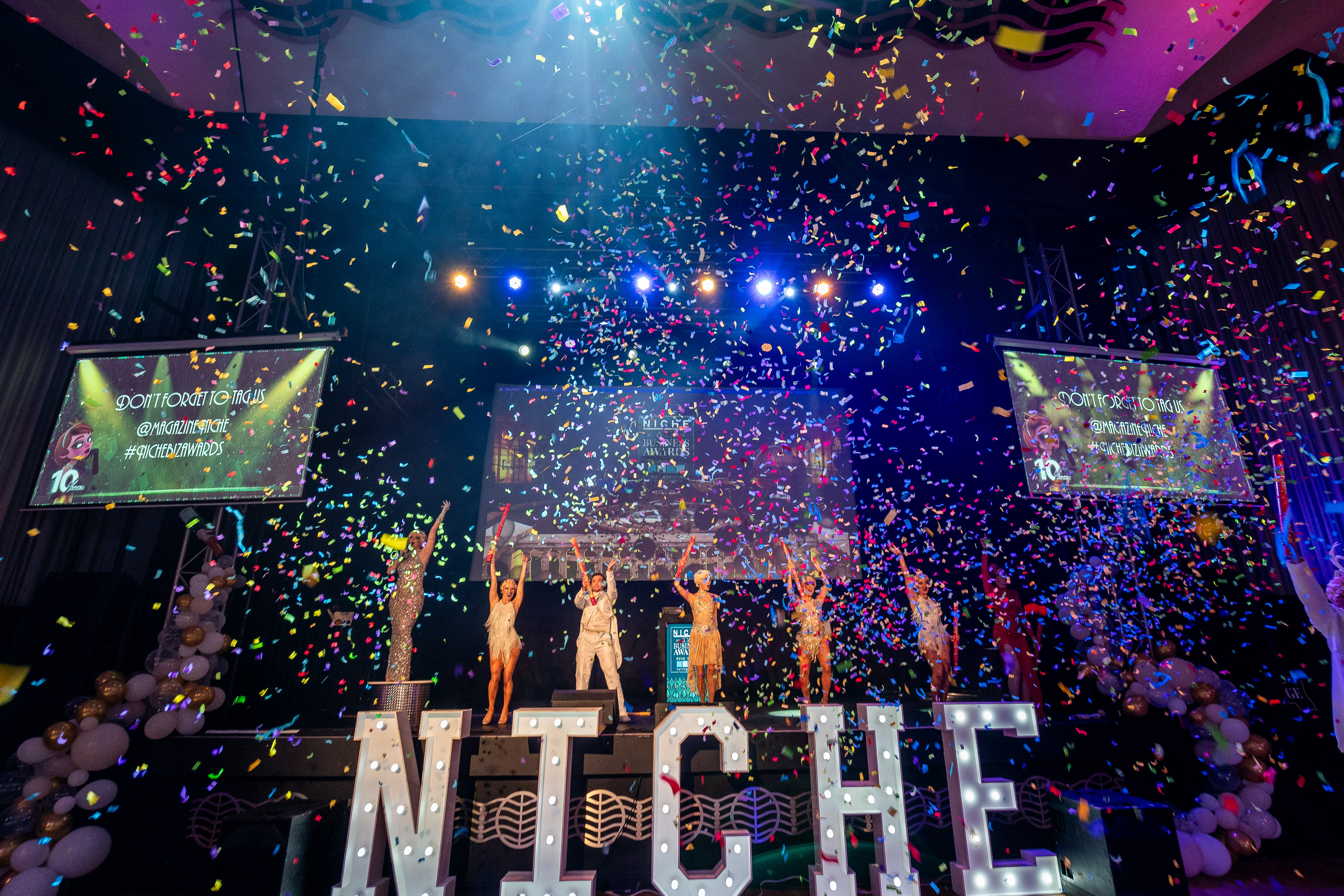 Niche Business Awards 2024 dancers pose on stage with confetti falling all around them