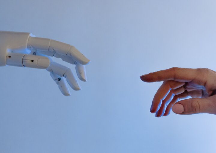 human hand moving towards robotic hand