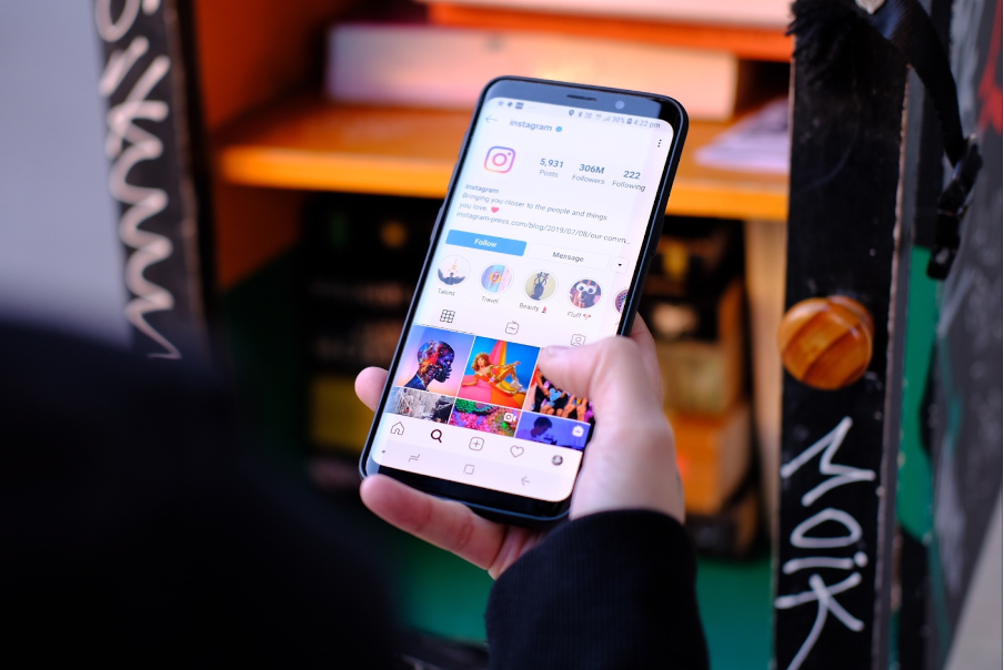 small business owner looking at Instagram profile on their smartphone